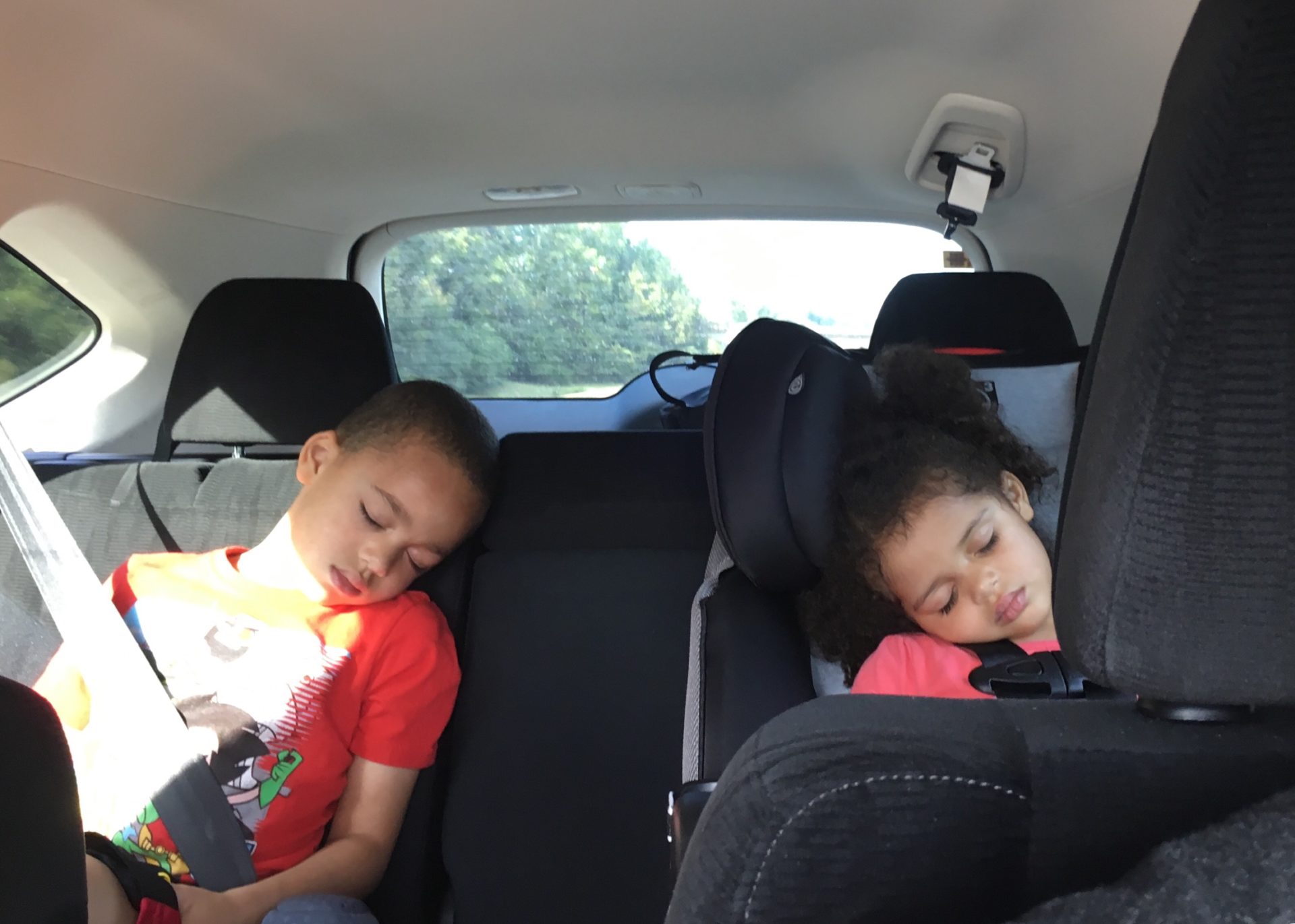 the kids sleeping in the Honda